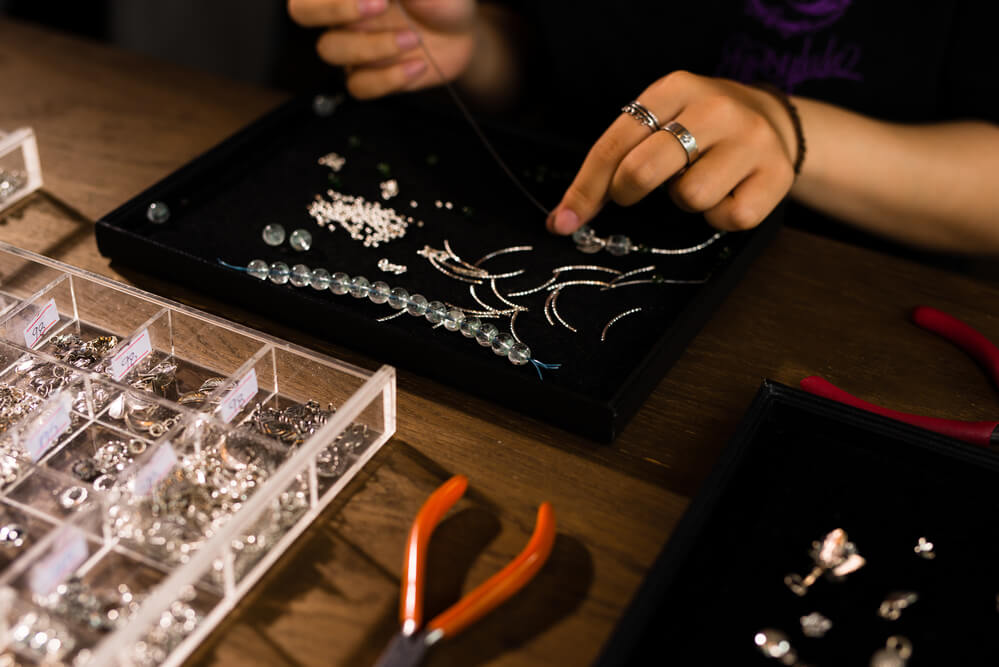 Female designer making jewelries at a jewelry shop - Shira Diamonds
